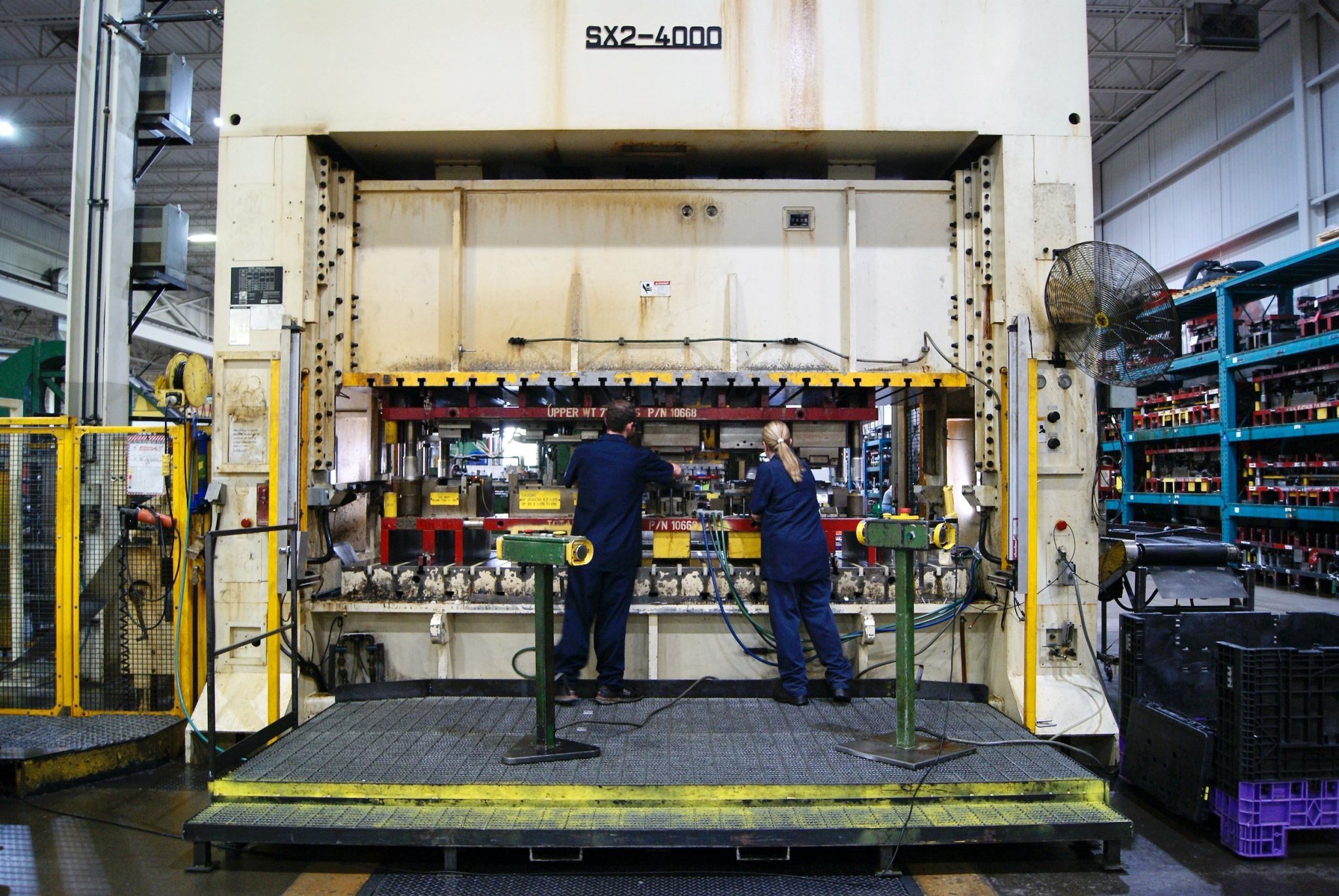 Workers at Metal Stamping Machine