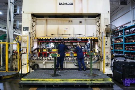 Workers at Metal Stamping Machine